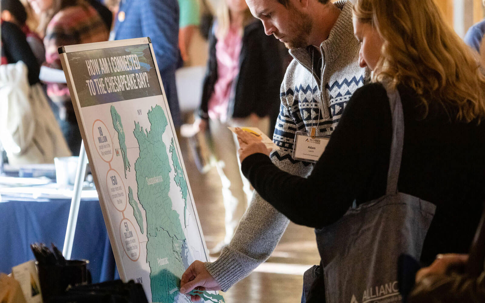 Attendees interacting with the A Connected Chesapeake Bay magnetic display